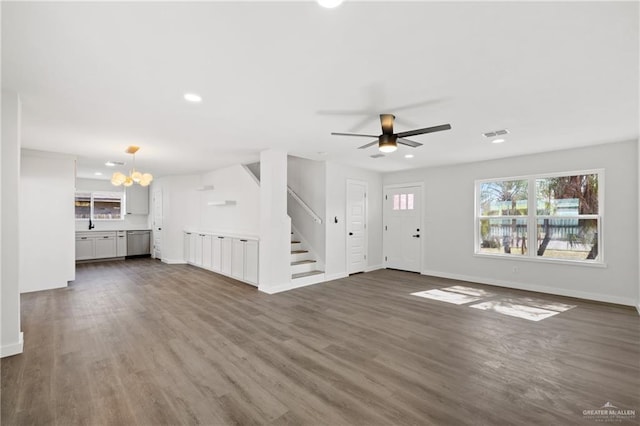 3400 Ozark Ave, Mcallen, TX 78504 - unfurnished living room featuring baseboards, recessed lighting, dark wood-style floors, stairs, and visible vents