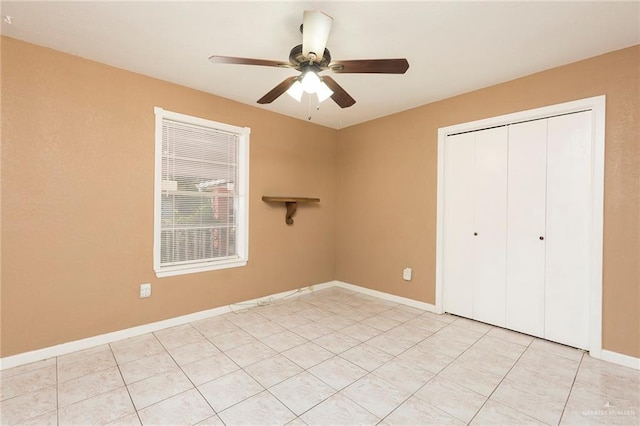 unfurnished bedroom featuring light tile patterned floors, a closet, and ceiling fan