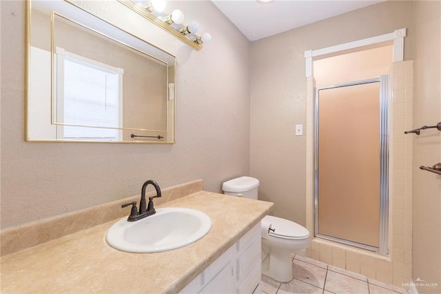 bathroom featuring tile patterned flooring, vanity, an enclosed shower, and toilet