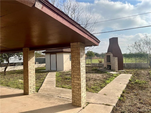 exterior space with a fireplace and a shed