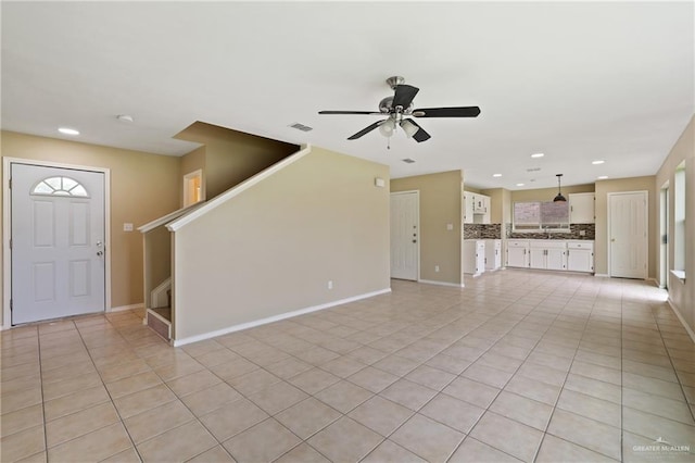 1730 W Jefferson St, Weslaco, TX 78599 - unfurnished living room featuring stairs, light tile patterned flooring, ceiling fan, baseboards, and recessed lighting
