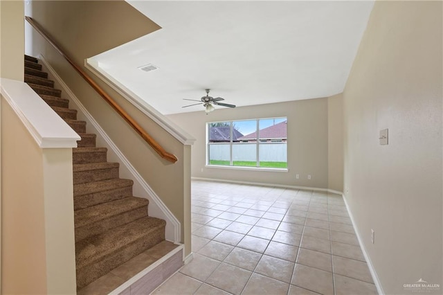 1730 W Jefferson St, Weslaco, TX 78599 - stairs featuring a ceiling fan, tile patterned flooring, and baseboards