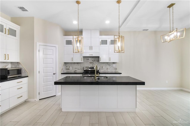3100 E Zinnia Ave, Alton, TX 78573 - kitchen with stainless steel appliances, a sink, dark countertops, decorative backsplash, and under cabinet range hood