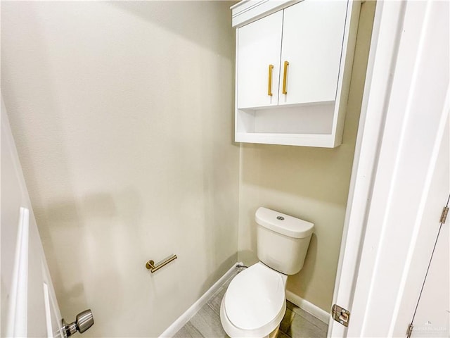3100 E Zinnia Ave, Alton, TX 78573 - bathroom featuring baseboards and toilet