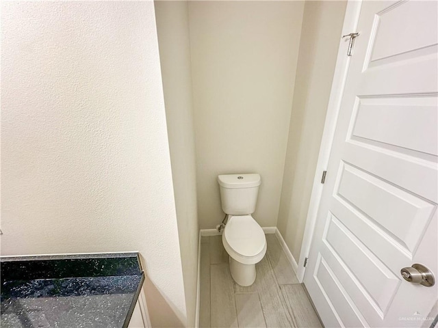 3100 E Zinnia Ave, Alton, TX 78573 - bathroom featuring toilet, baseboards, and tile patterned flooring
