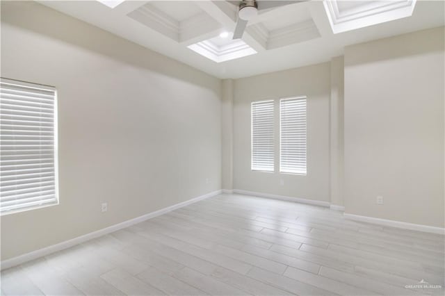 3100 E Zinnia Ave, Alton, TX 78573 - spare room featuring coffered ceiling, beam ceiling, baseboards, a ceiling fan, and light wood-type flooring