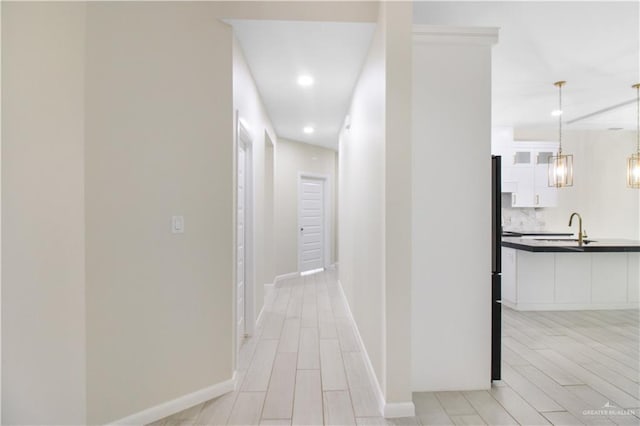 3100 E Zinnia Ave, Alton, TX 78573 - corridor featuring recessed lighting, a sink, baseboards, and light wood-type flooring