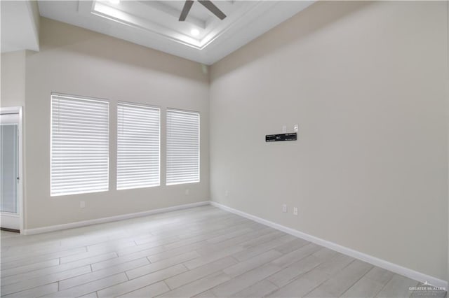 3100 E Zinnia Ave, Alton, TX 78573 - unfurnished room with a raised ceiling, a ceiling fan, light wood-type flooring, and baseboards