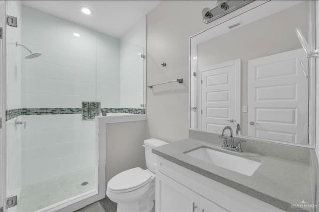 bathroom with vanity, an enclosed shower, and toilet