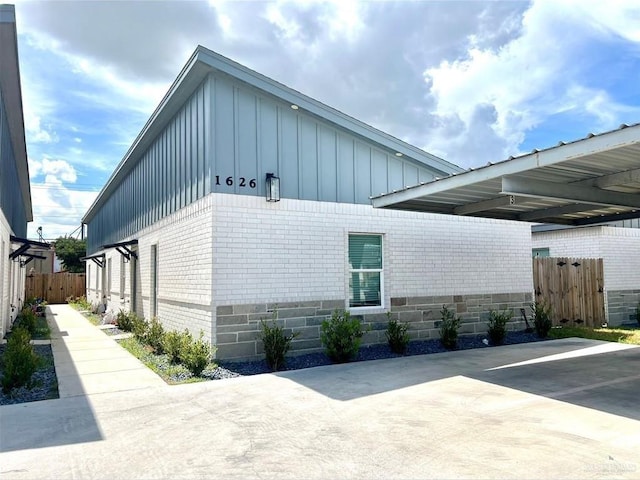 view of side of property with a carport