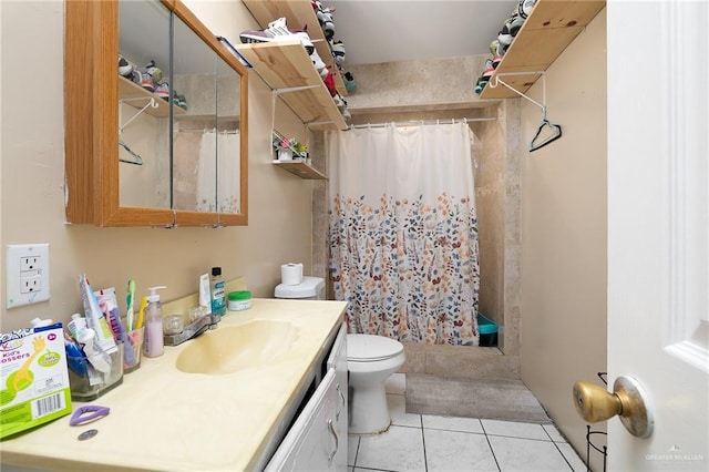 full bathroom featuring vanity, a tile shower, toilet, and tile patterned floors