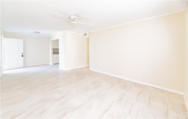 spare room featuring ceiling fan and crown molding