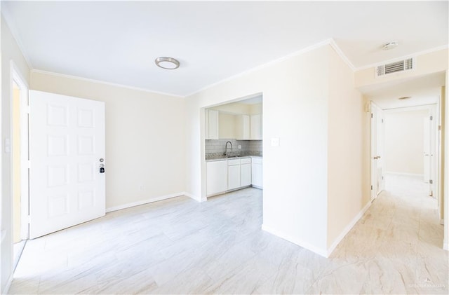 interior space with ornamental molding and sink