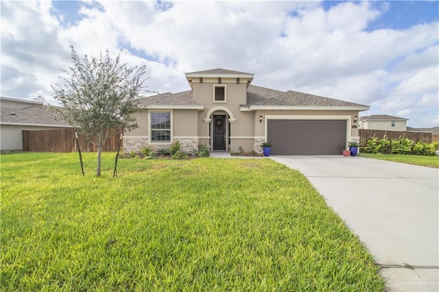 view of front of home with a garage and a front lawn