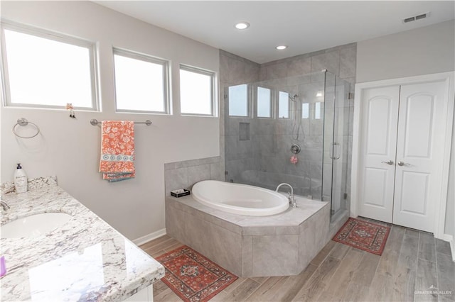 bathroom featuring vanity and separate shower and tub