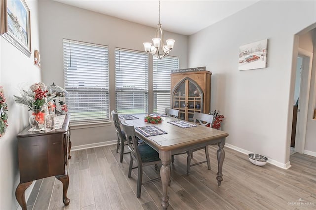 dining area featuring a notable chandelier and hardwood / wood-style flooring