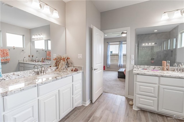 bathroom featuring vanity, an enclosed shower, and ceiling fan