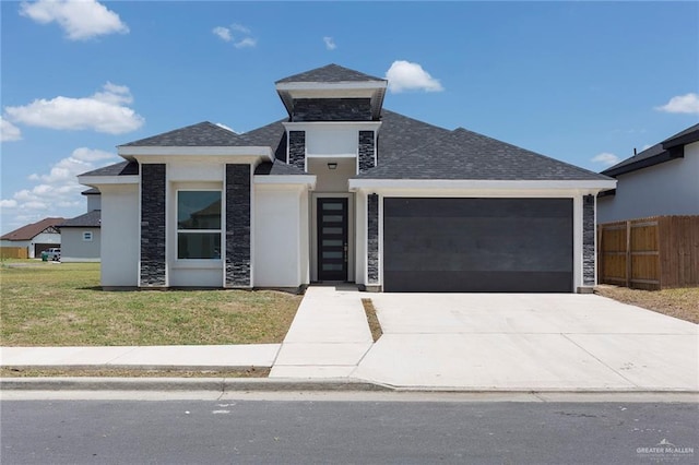 view of front facade featuring a garage and a front yard