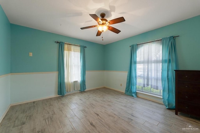 empty room featuring ceiling fan and light hardwood / wood-style floors