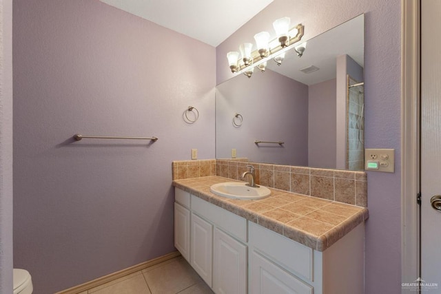 bathroom with tile patterned floors, vanity, and toilet