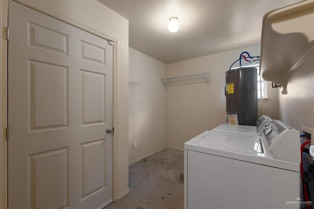 clothes washing area with washer and dryer, light carpet, and electric water heater