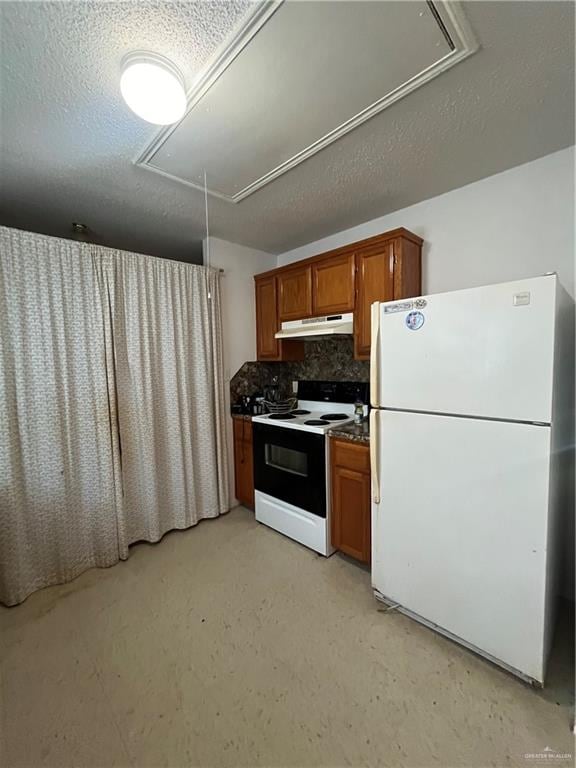 kitchen featuring decorative backsplash, white appliances, and a textured ceiling