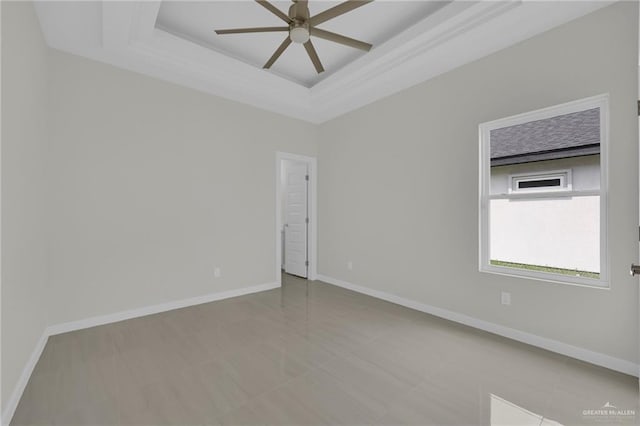 1015 Magnolia St, Mission, TX 78573 - empty room featuring a raised ceiling, a ceiling fan, baseboards, and tile patterned flooring