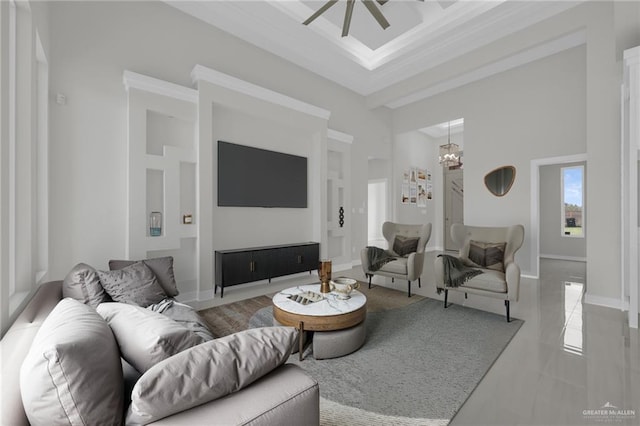 1015 Magnolia St, Mission, TX 78573 - living room with a high ceiling, ceiling fan, a chandelier, and crown molding