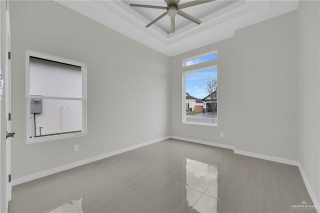 1015 Magnolia St, Mission, TX 78573 - empty room with a raised ceiling, ceiling fan, and baseboards
