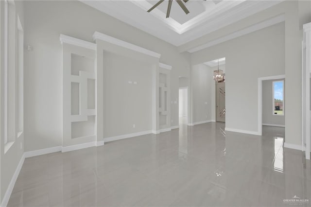 1015 Magnolia St, Mission, TX 78573 - empty room with ceiling fan, a chandelier, a high ceiling, ornamental molding, and light tile patterned flooring