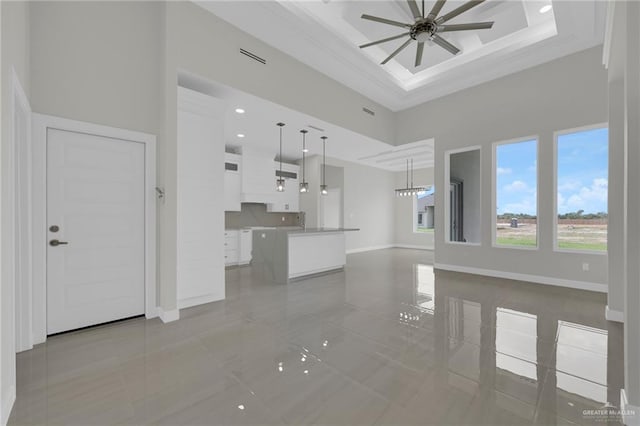 1015 Magnolia St, Mission, TX 78573 - unfurnished living room featuring a high ceiling, ceiling fan, baseboards, and ornamental molding