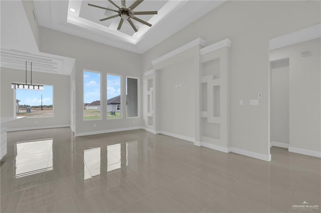 1015 Magnolia St, Mission, TX 78573 - tiled spare room featuring a ceiling fan, baseboards, and a towering ceiling