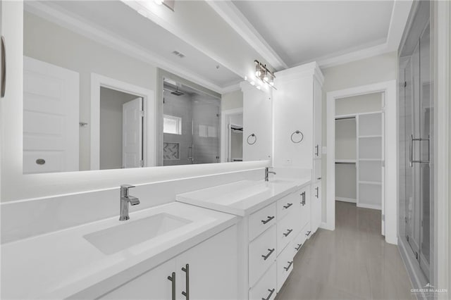 1015 Magnolia St, Mission, TX 78573 - bathroom featuring a stall shower, double vanity, a walk in closet, and ornamental molding