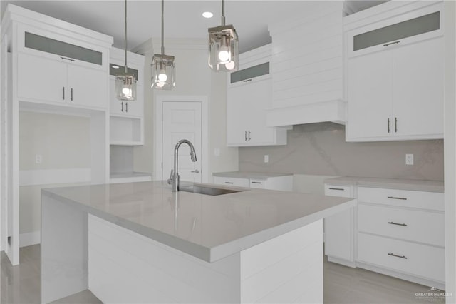 1015 Magnolia St, Mission, TX 78573 - kitchen with a sink, an island with sink, white cabinets, glass insert cabinets, and pendant lighting