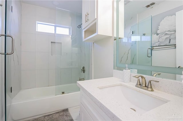 bathroom featuring vanity and combined bath / shower with glass door