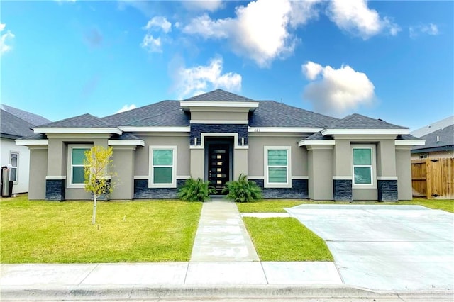 prairie-style house featuring a front lawn