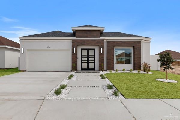 prairie-style house with a garage and a front yard