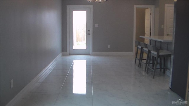 unfurnished dining area featuring dark tile patterned floors