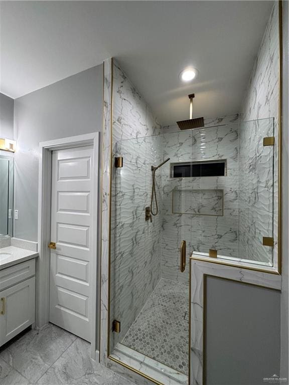 bathroom with vanity and a shower with shower door