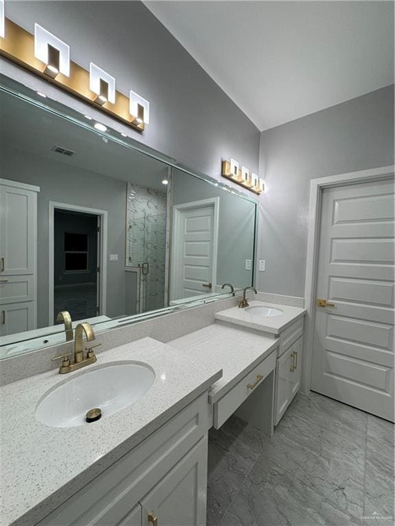 bathroom featuring walk in shower and vanity