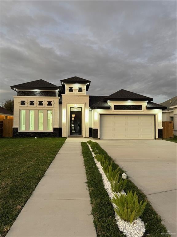 prairie-style house with a garage and a front yard