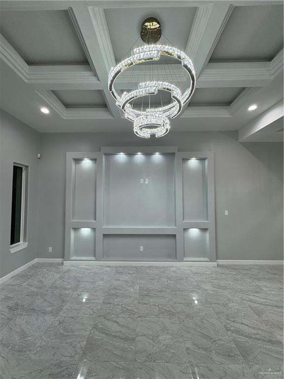 spare room with beamed ceiling, ornamental molding, coffered ceiling, and a notable chandelier