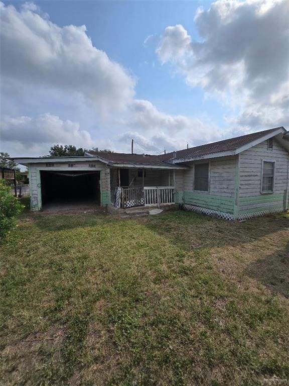 1714 E Loeb St, Edinburg, TX 78541 - back of house with an attached garage, a yard, and a porch