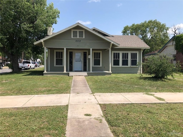 222 W Buchanan St, Harlingen, TX 78550 - bungalow featuring a front lawn, covered porch, and a chimney