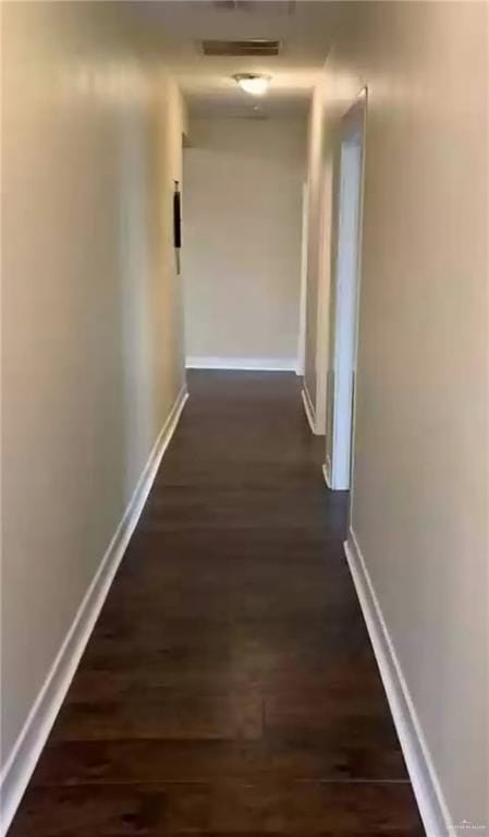222 W Buchanan St, Harlingen, TX 78550 - hallway featuring baseboards and dark wood-style floors