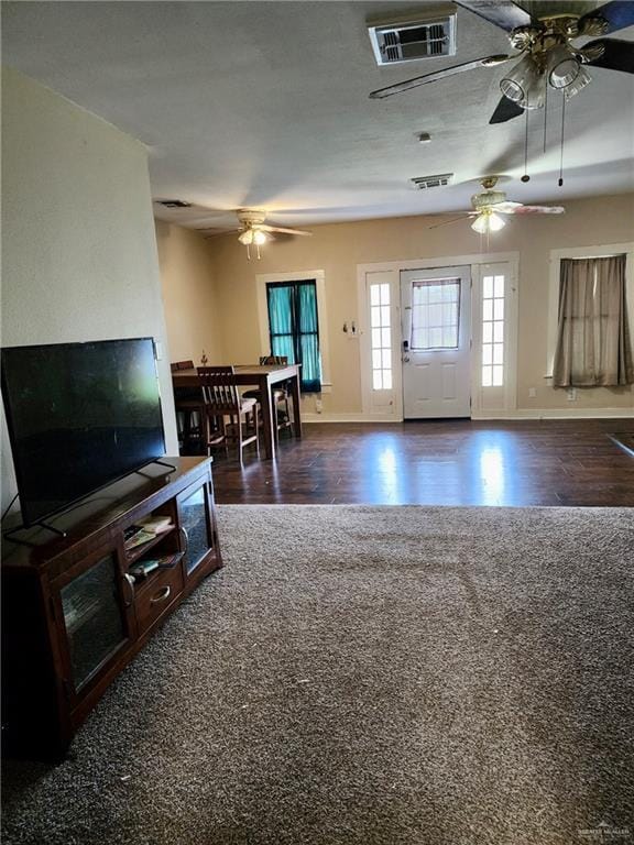 222 W Buchanan St, Harlingen, TX 78550 - living room featuring baseboards, a ceiling fan, wood finished floors, and visible vents