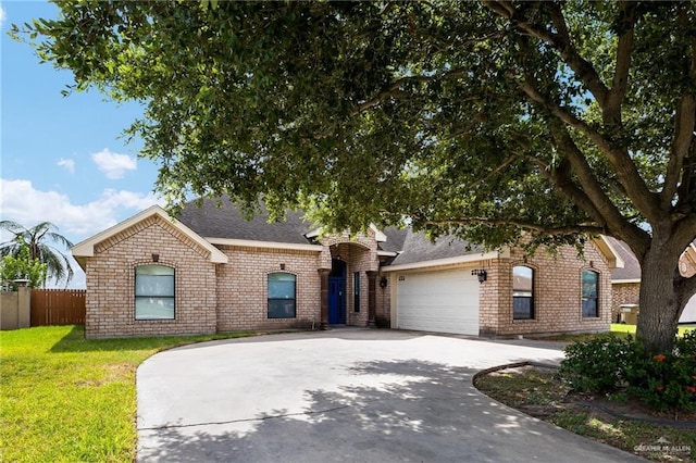 view of front of house featuring a garage and a front lawn