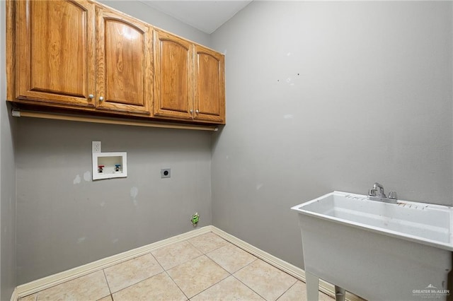 laundry area with cabinets, hookup for a washing machine, light tile patterned floors, and hookup for an electric dryer