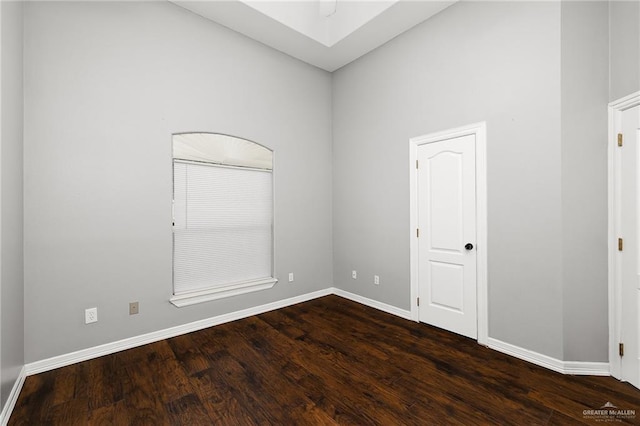 unfurnished room featuring dark hardwood / wood-style flooring