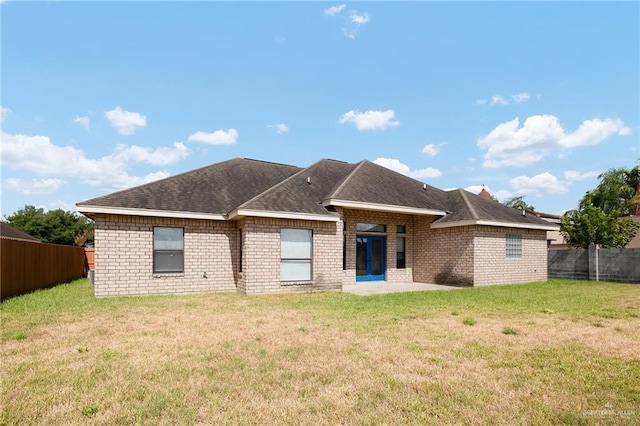 back of house with a patio area and a lawn